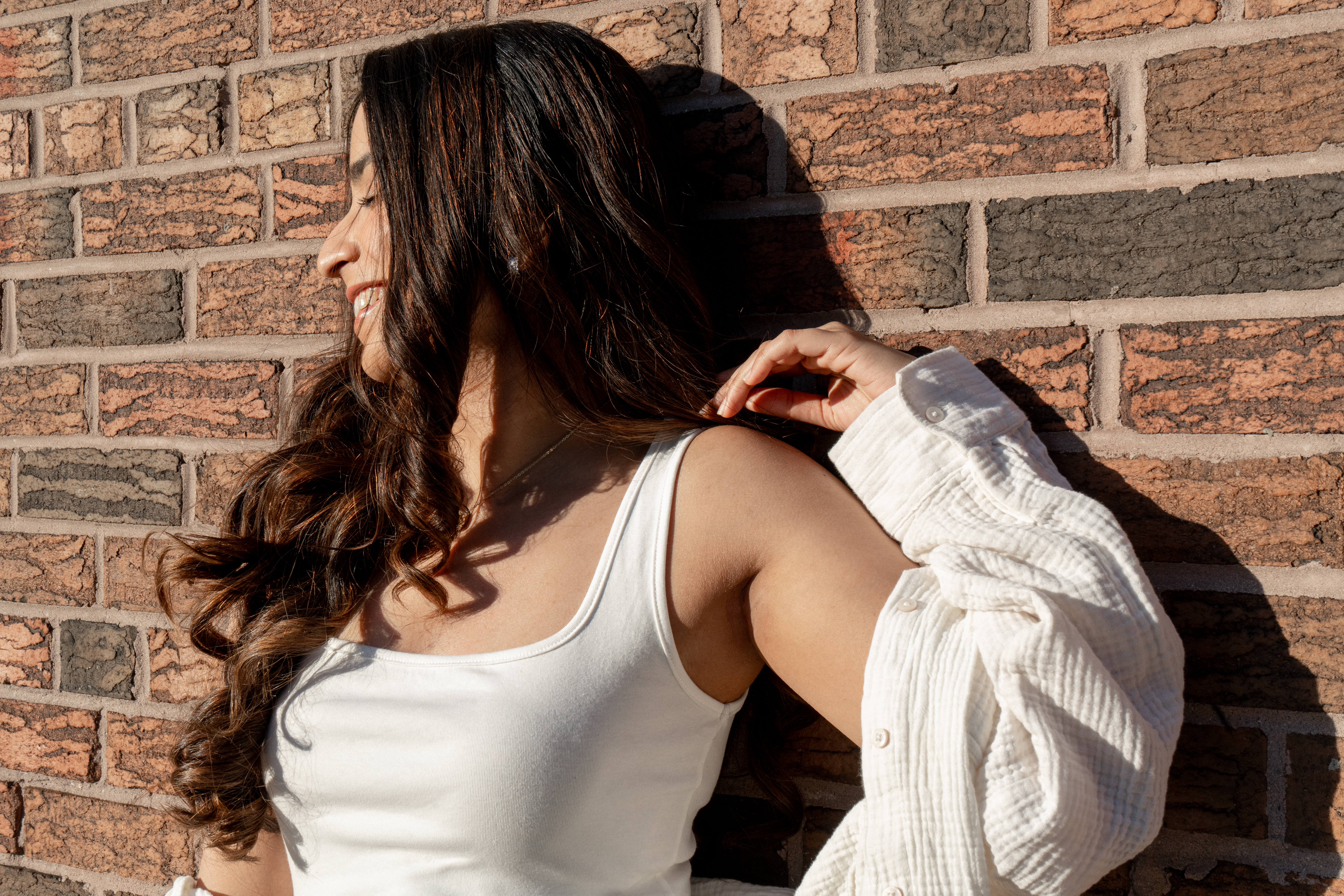 Candid portrait against brick wall