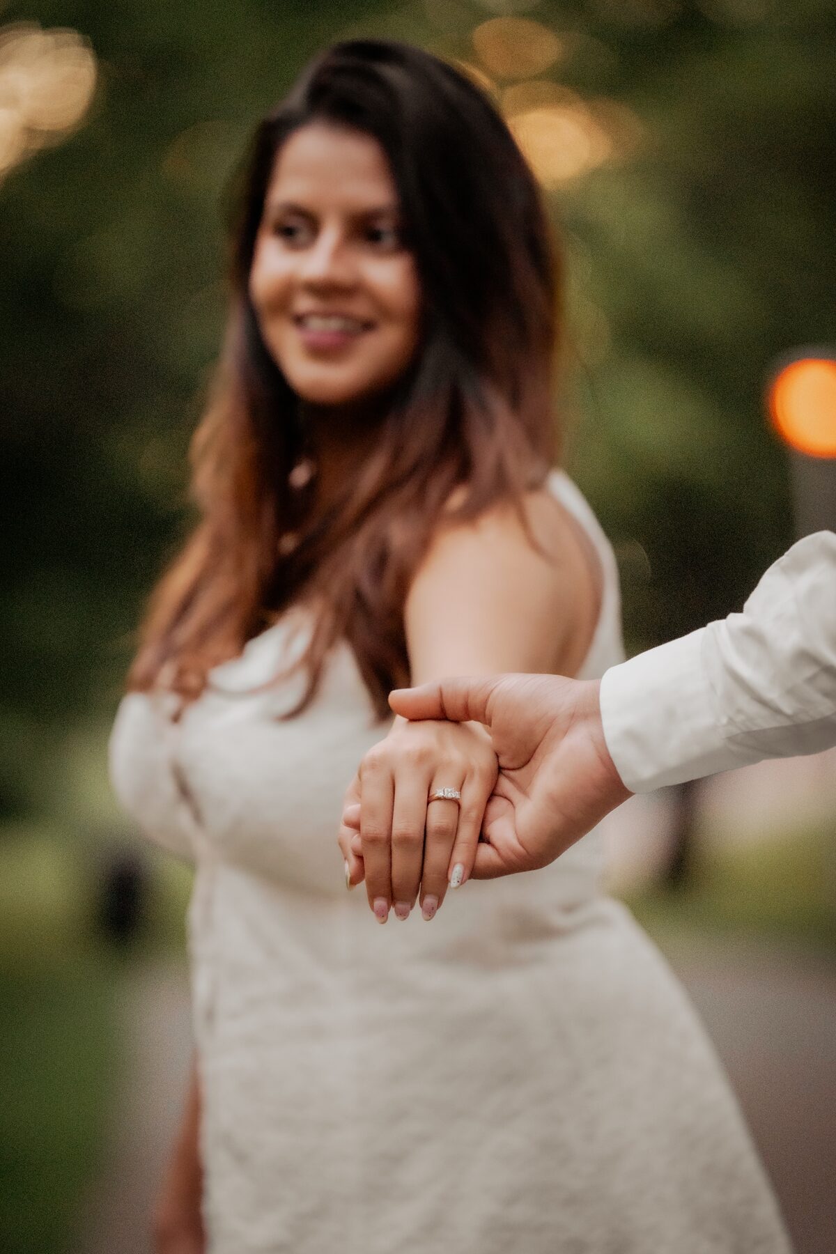 Close-up hands with engagement ring