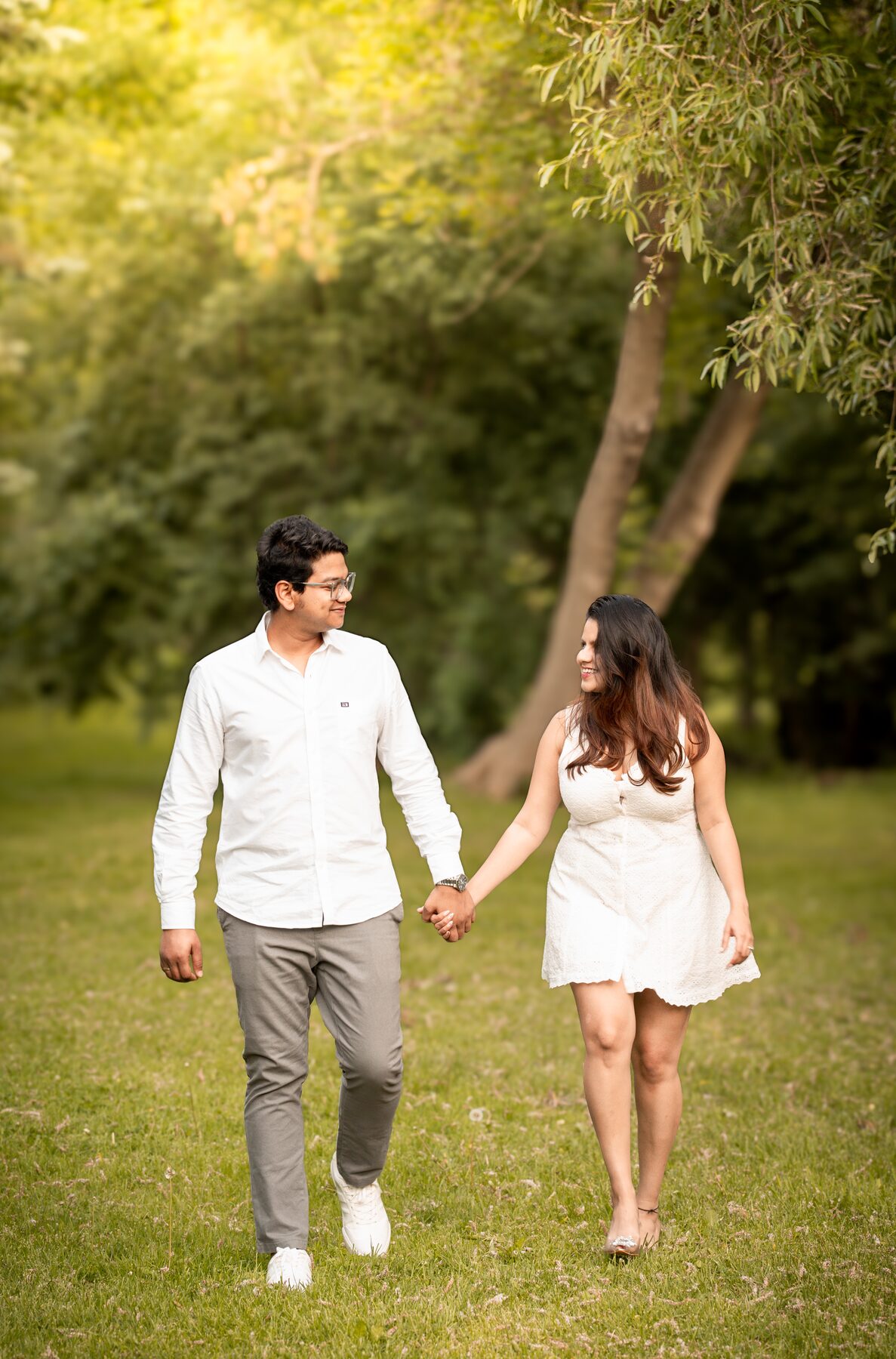 Couple walking together through warm greenery