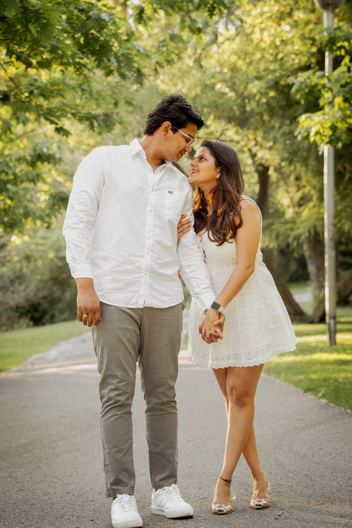 Couple walking together on a tree-lined path